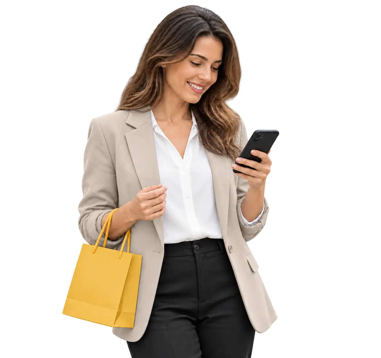 A smiling shopper in a light stone blazer using a phone while holding a mustard shopping bag